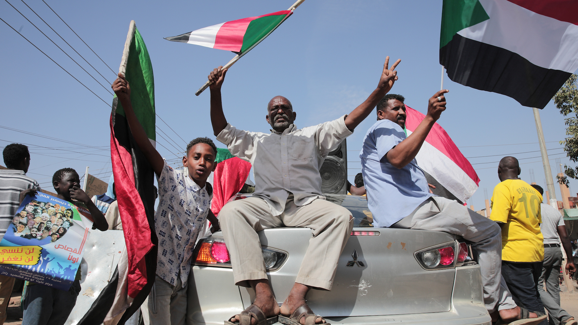 Sudanese demonstrators march in Khartoum, Sudan, Monday, Dec. 19, 2022 to protest a deal signed between the country's main pro-democracy group and its ruling generals, who seized power in an October 2021 coup.