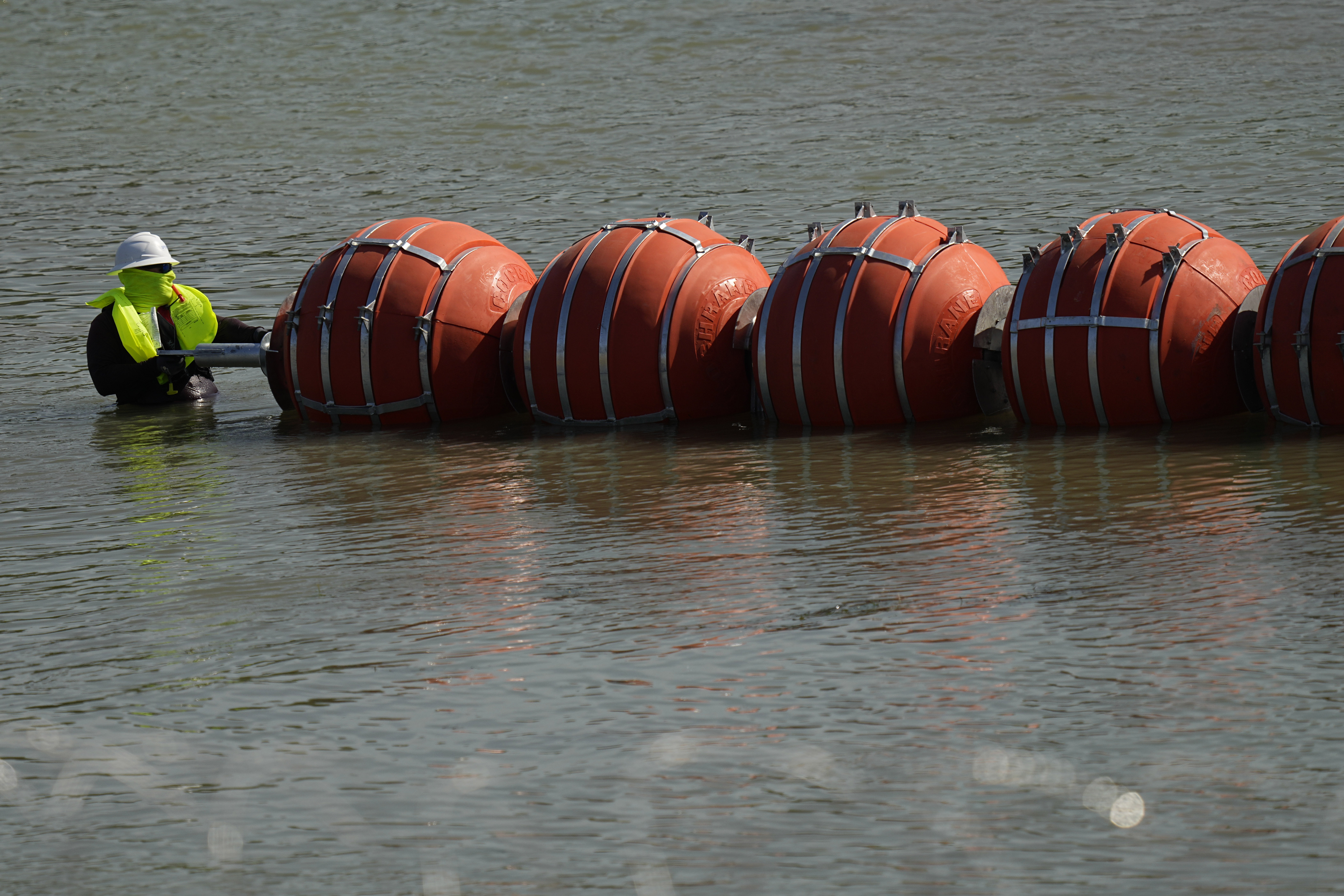 Texas installs huge buoys to block migrants from crossing river 