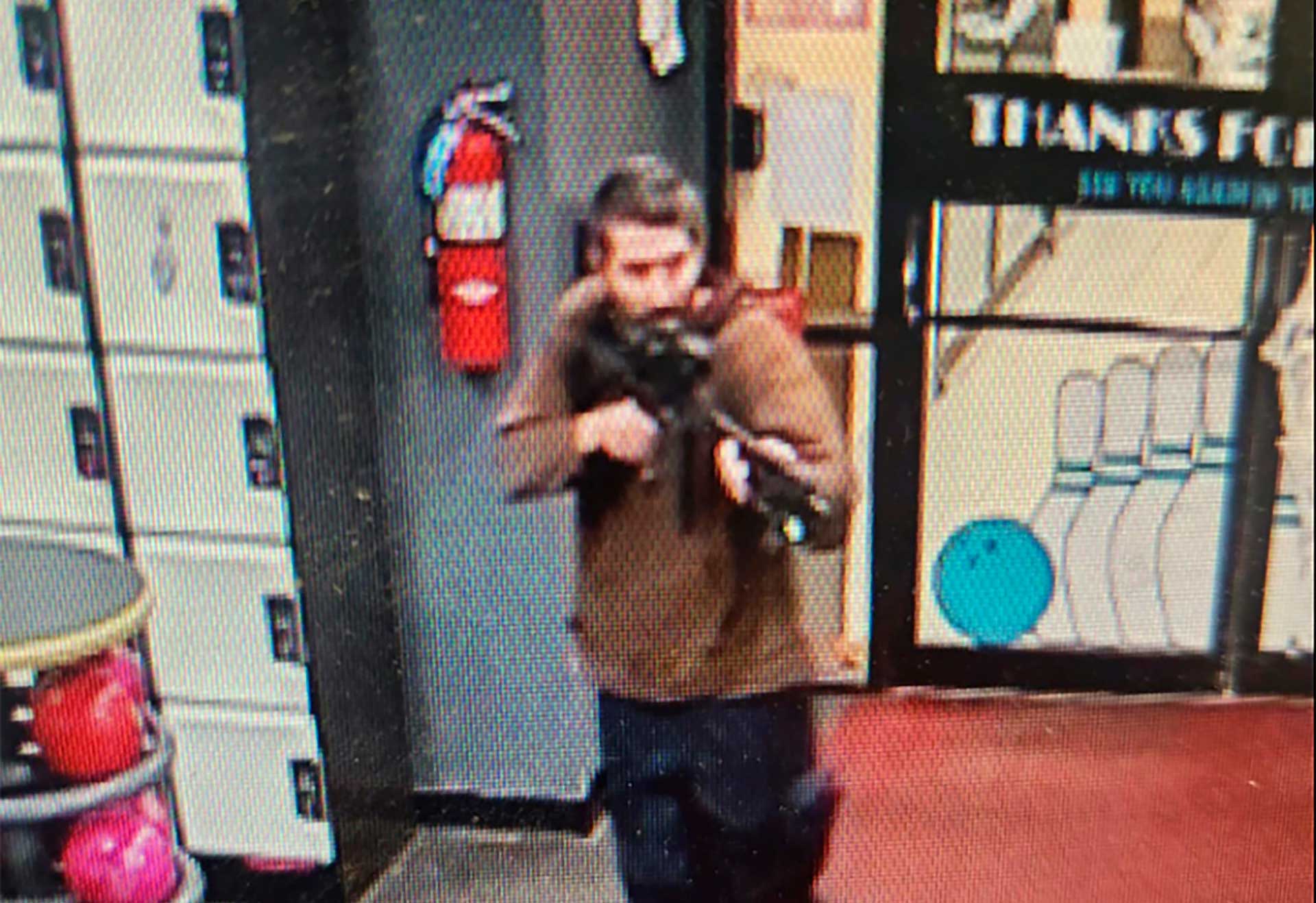 In this image taken from video released by the Androscoggin County Sheriff's Office, shows the d gunman pointing a gun while entering Sparetime Recreation in Lewiston, Maine, on Wednesday, Oct 25. (Androscoggin County Sheriff's Office via AP)