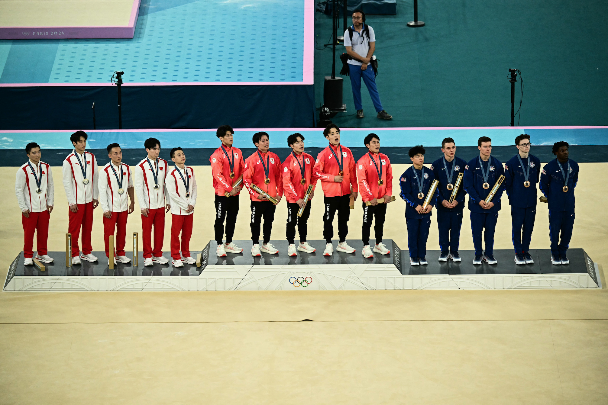 Second-placed China’s team, winner Japan’s team and third-placed USA team celebrate during the podium ceremony for the artistic gymnastics men’s team final during the Paris 2024 Olympic Games at the Bercy Arena in Paris, on July 29, 2024. PHOTO: LOIC VENANCE / AFP