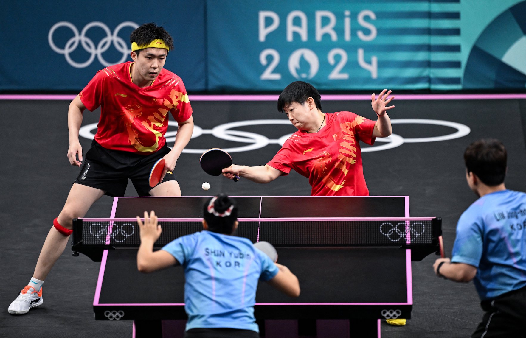 China’s Wang Chuqin (L) and China’s Sun Yingsha (R) play a return to South Korea’s Lim Jonghoon and South Korea’s Shin Yubin during their mixed table tennis doubles semifinals at the Paris 2024 Olympic Games on July 29, 2024. PHOTO: JUNG YEON-JE / AFP