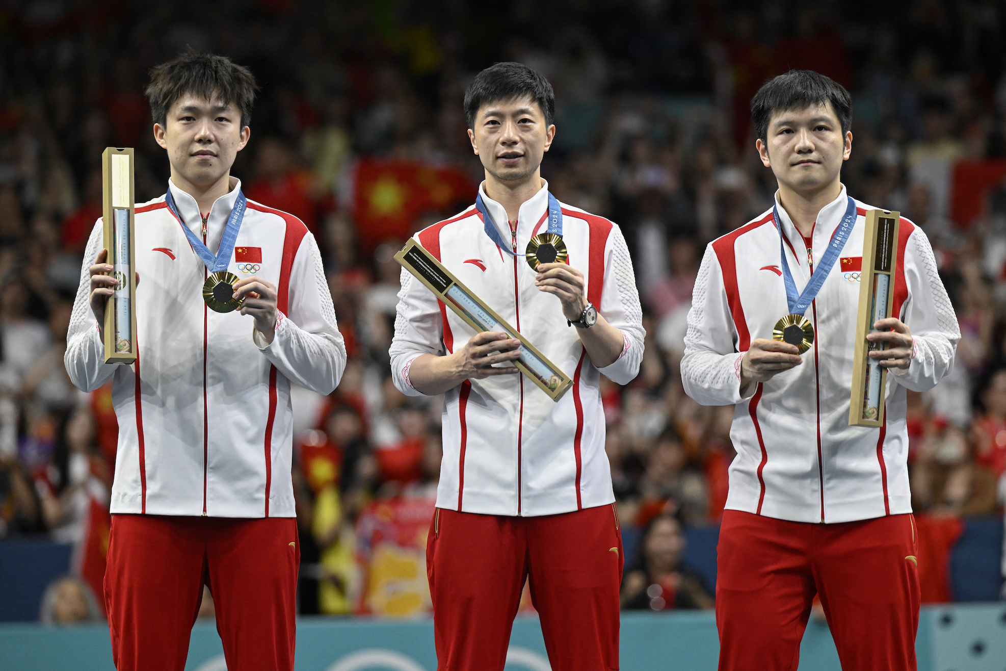 Gold medallists China's Wang Chuqin, China's Ma Long and China's Fan Zhendong pose with their medals on the podium of the men's table tennis team event at the Paris 2024 Olympic Games on August 9, 2024.
Photo: WANG Zhao / AFP