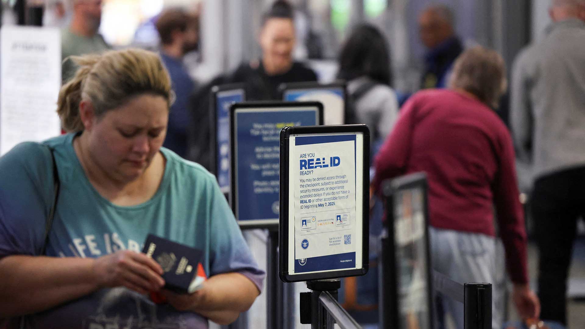 Travelers pass through a Transportation Security Administration (TSA) document check at Hollywood Burbank Airport during the first day of a partial U.S. government shutdown in Burbank, California, U.S., October 1, 2025. REUTERS/Daniel Cole