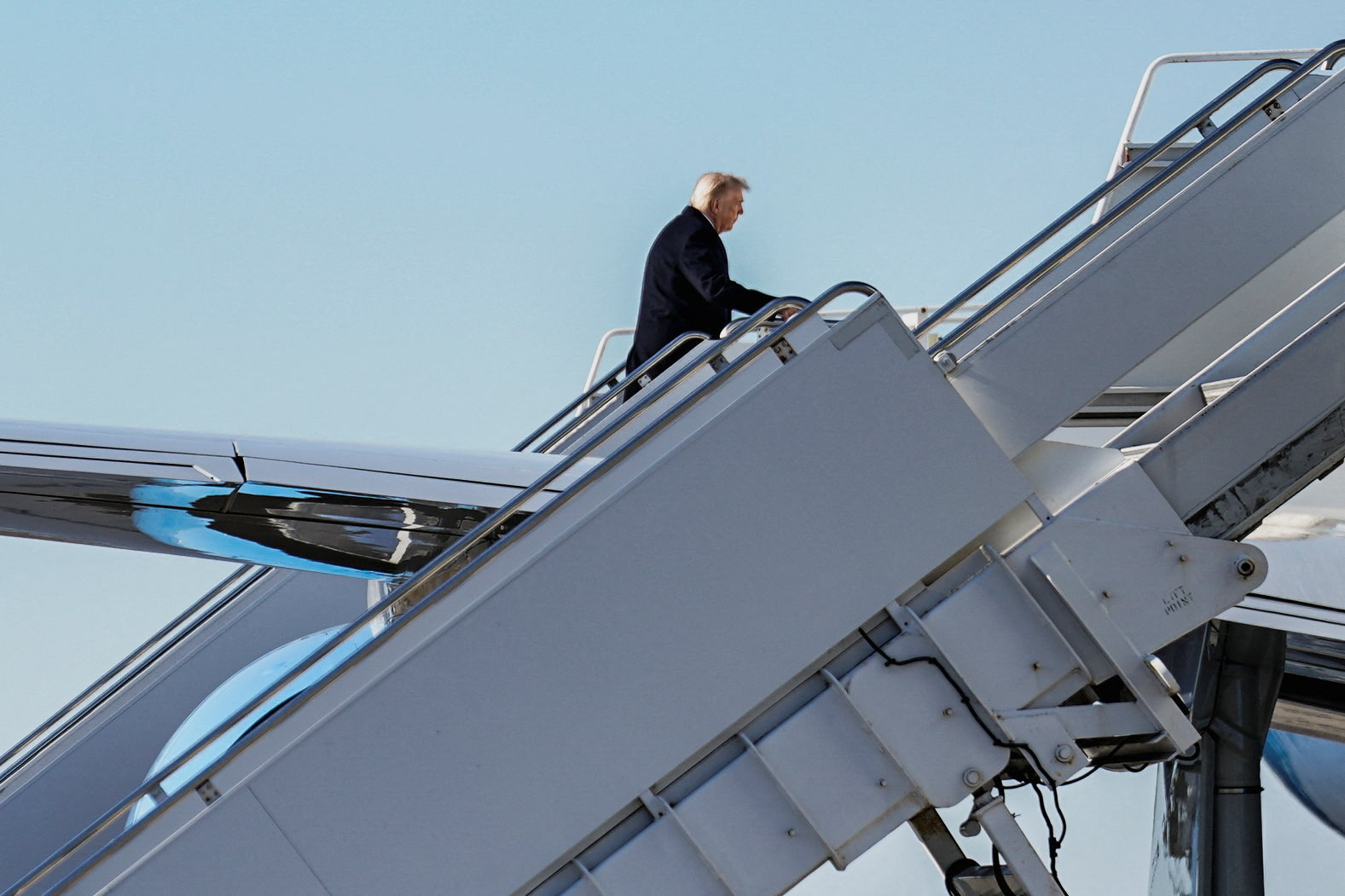 U.S. President Donald Trump boards Air Force One en route to the White House at Palm Beach International Airport, Florida. February 1, 2026.