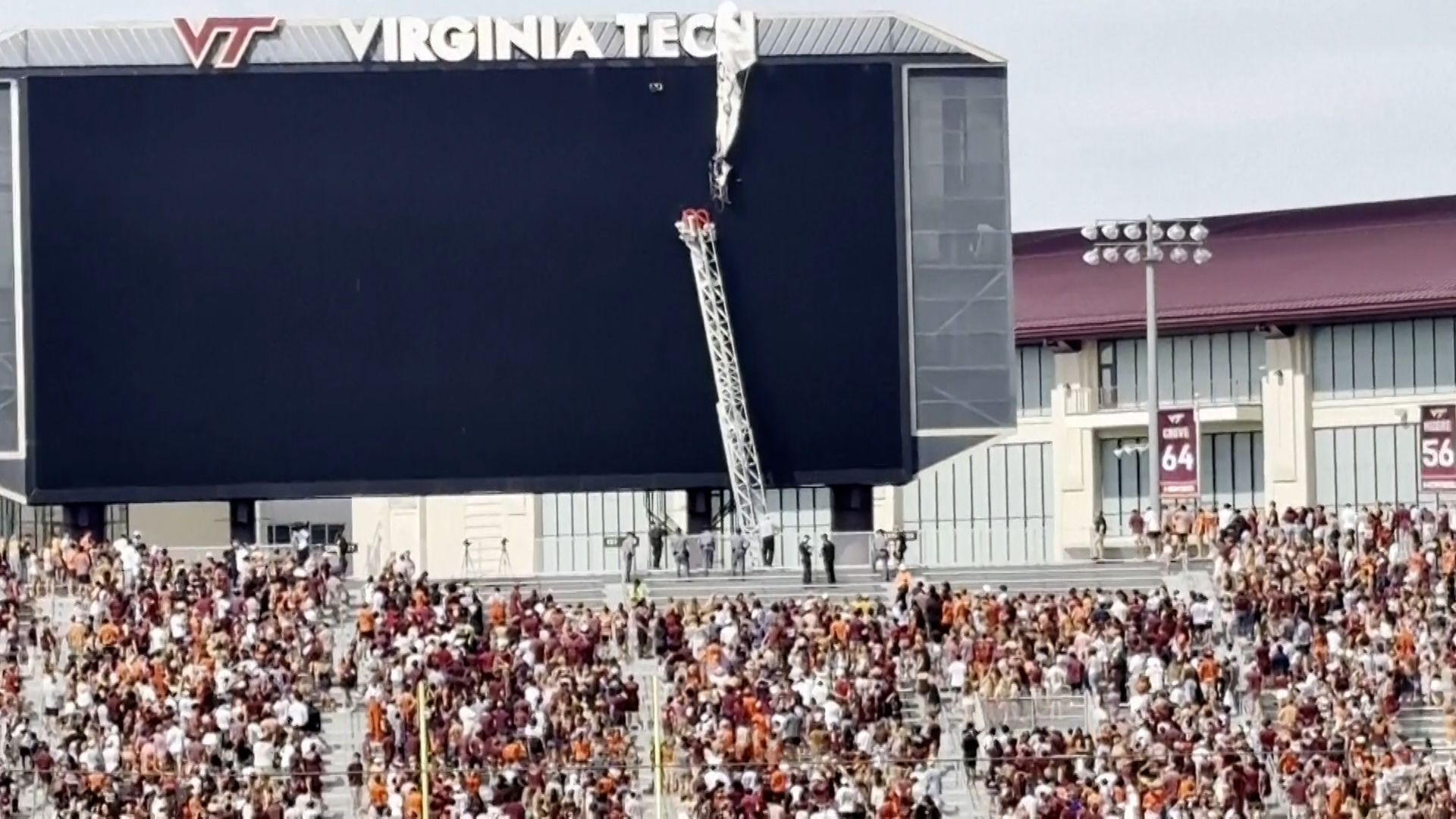 Skydiver rescued from scoreboard during spring football game