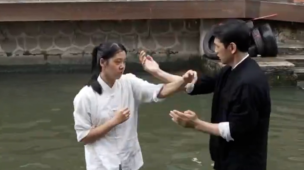 Father-daughter duo practice Wing Chun on dragon boat