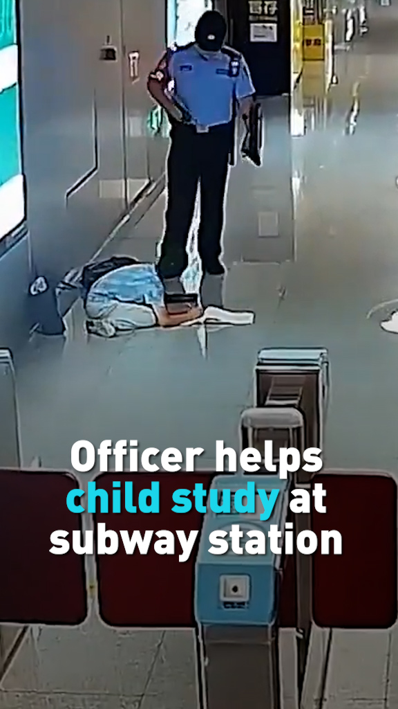 Officer helps child study at subway station